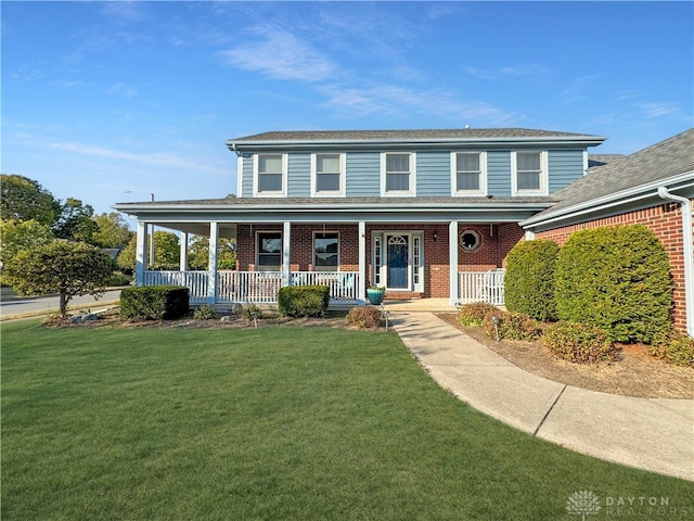 view of front of property featuring a front lawn and a porch