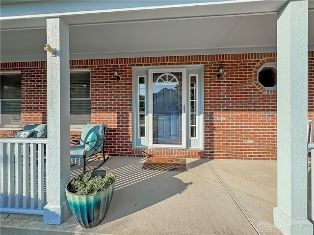 view of exterior entry with covered porch