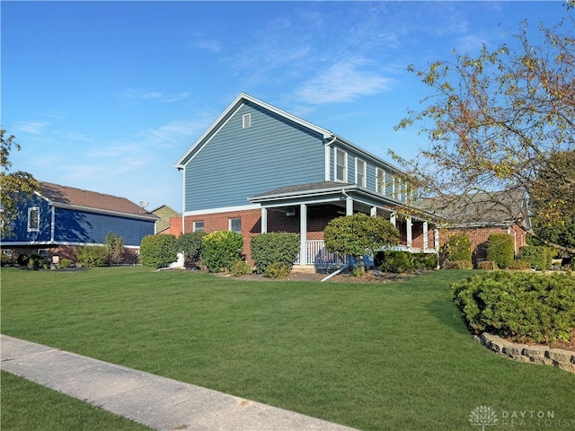 view of front of property with a porch and a front lawn