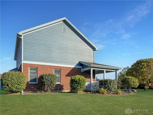 rear view of property featuring a yard