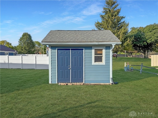 view of outbuilding featuring a yard