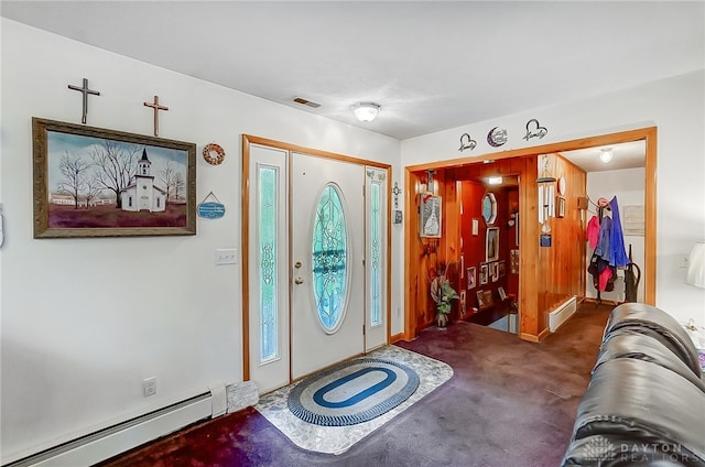 carpeted entryway featuring a baseboard heating unit