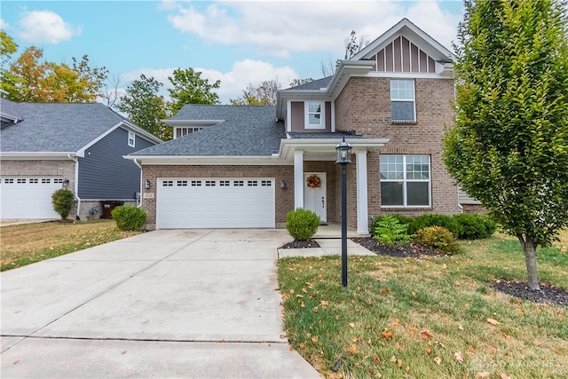 view of front of property with a front yard and a garage