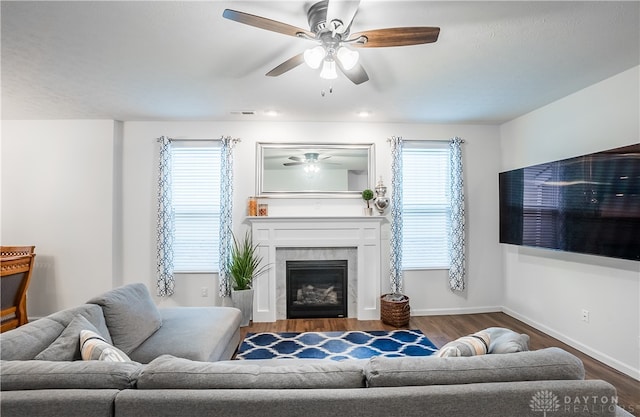 living room with ceiling fan, dark hardwood / wood-style floors, and a fireplace