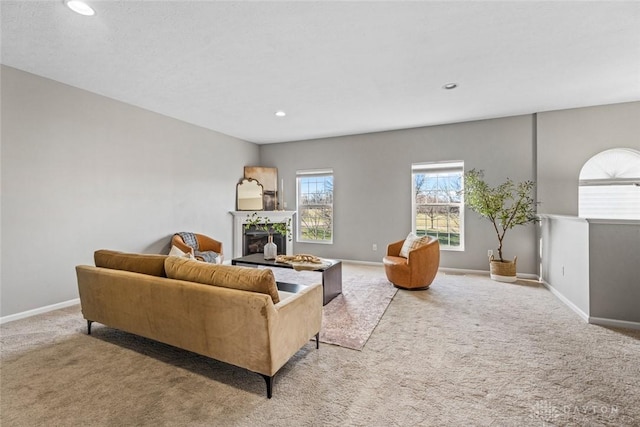 carpeted living room featuring a fireplace