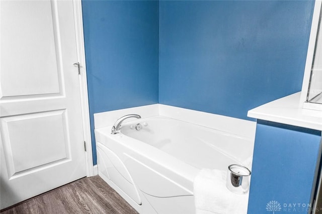 bathroom featuring hardwood / wood-style floors, vanity, and a bathing tub