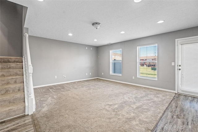 interior space featuring a textured ceiling and hardwood / wood-style flooring