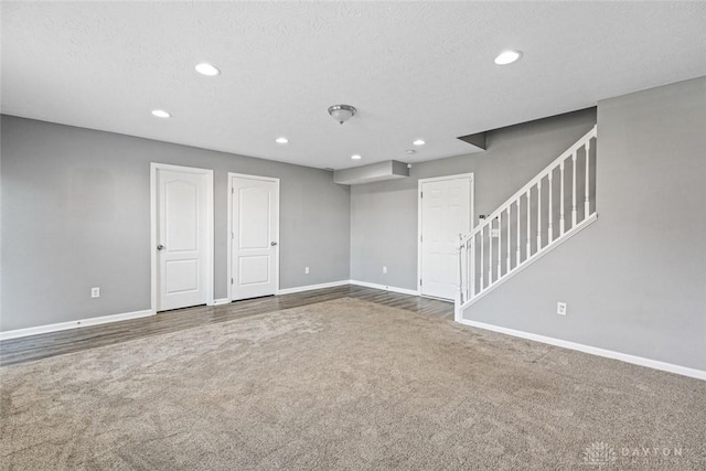 empty room with carpet flooring and a textured ceiling