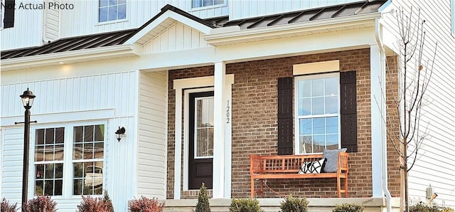 view of exterior entry with a porch