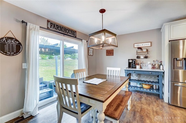 dining area featuring light wood-type flooring and an inviting chandelier