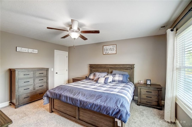 bedroom with light carpet and ceiling fan