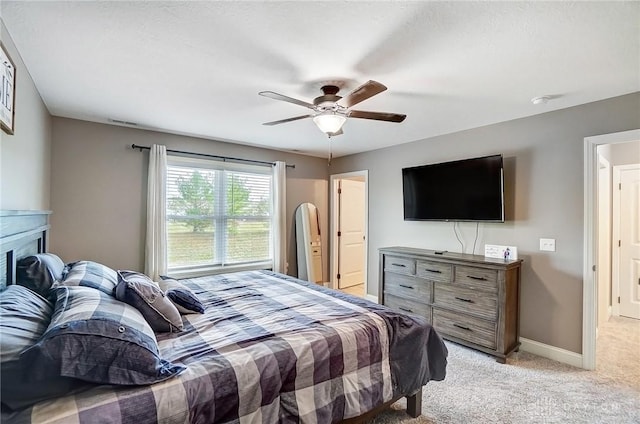 bedroom featuring light carpet and ceiling fan