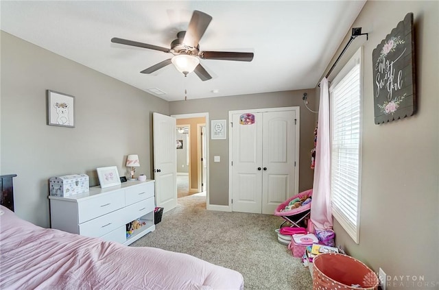 carpeted bedroom featuring a closet and ceiling fan