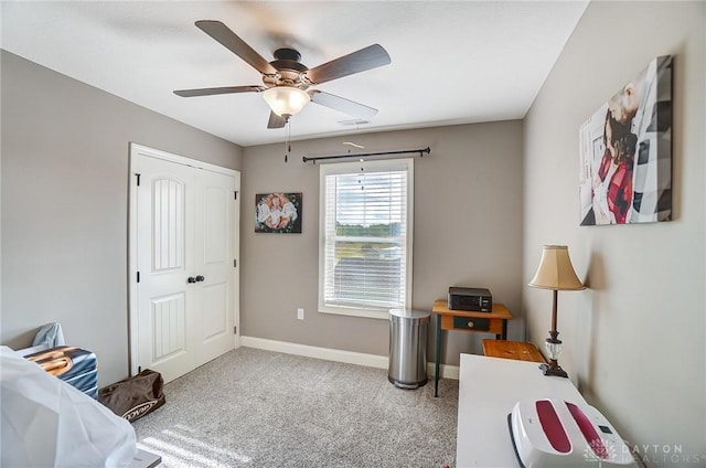 carpeted bedroom featuring ceiling fan and a closet