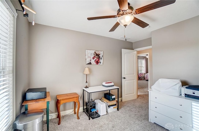 interior space featuring ceiling fan and light colored carpet