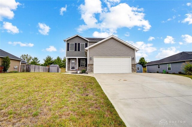 view of front of home featuring a front yard and a garage