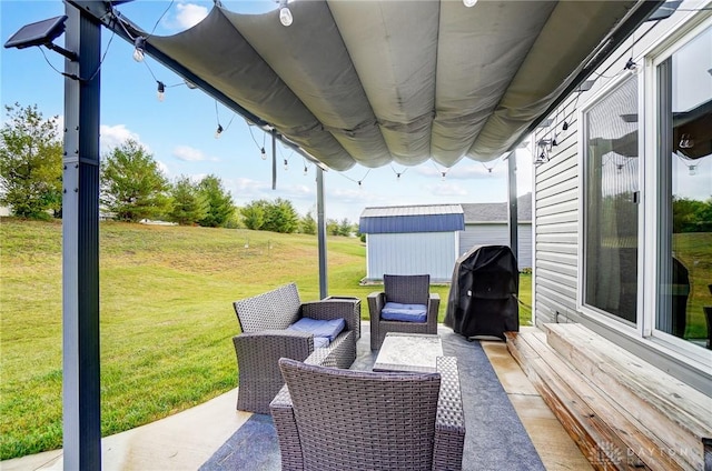 view of patio with area for grilling and a shed