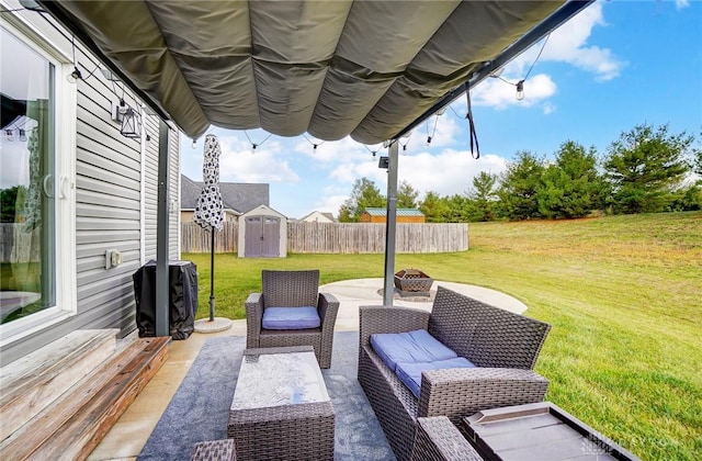 view of patio / terrace with a shed and an outdoor living space with a fire pit