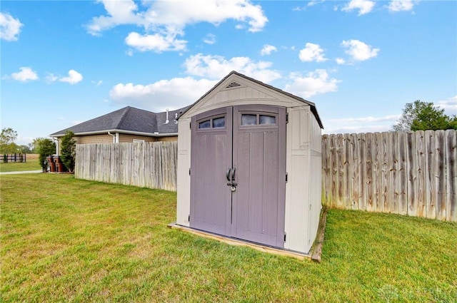 view of outbuilding featuring a lawn