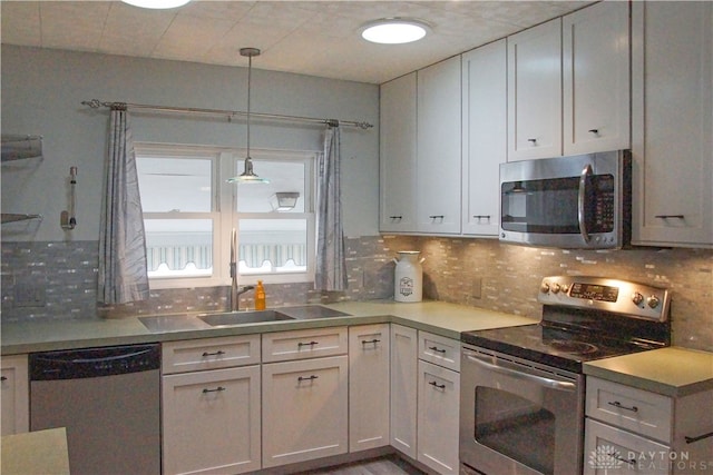 kitchen featuring white cabinets, decorative backsplash, stainless steel appliances, and sink