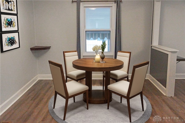 dining area with dark hardwood / wood-style flooring