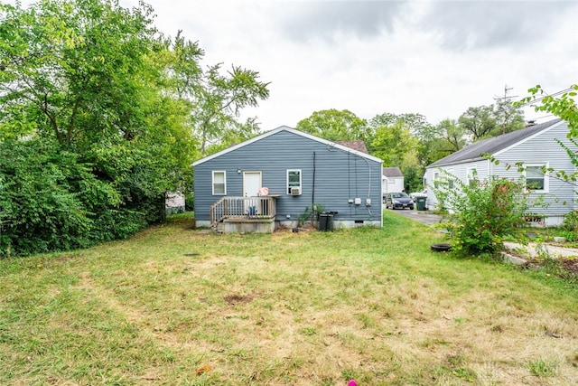 back of property featuring a yard and central air condition unit