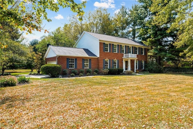 colonial inspired home with a front lawn