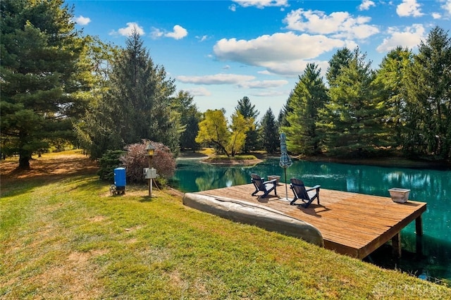 view of dock featuring a water view and a yard