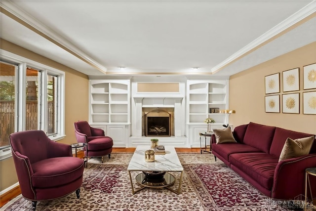 living room featuring a raised ceiling, crown molding, and hardwood / wood-style floors