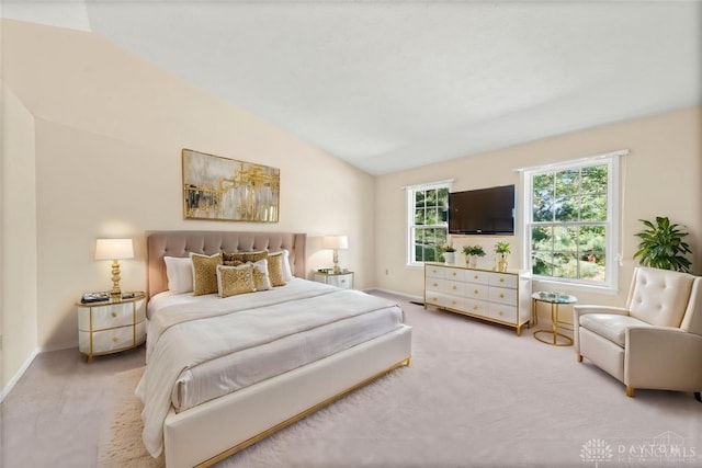 bedroom featuring vaulted ceiling and light carpet