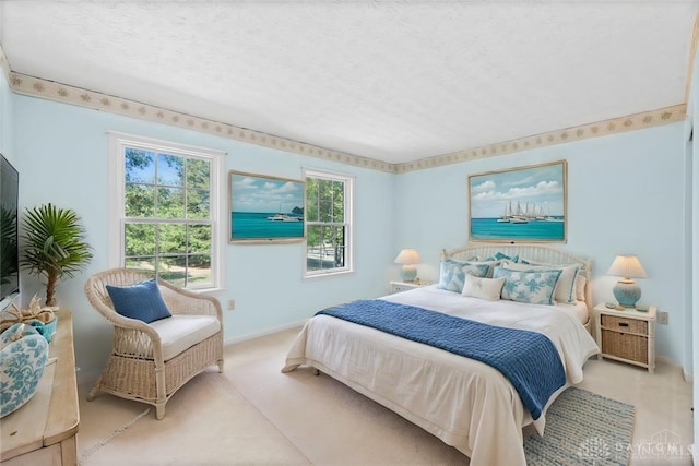 bedroom with a textured ceiling and light colored carpet