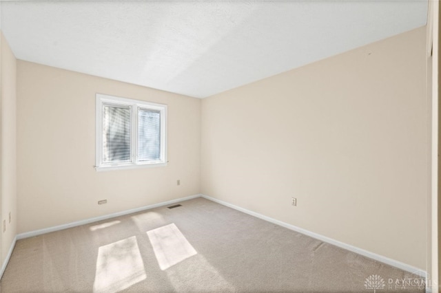 empty room featuring light colored carpet