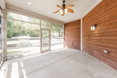 unfurnished sunroom featuring ceiling fan