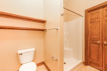 bathroom with toilet and walk in shower