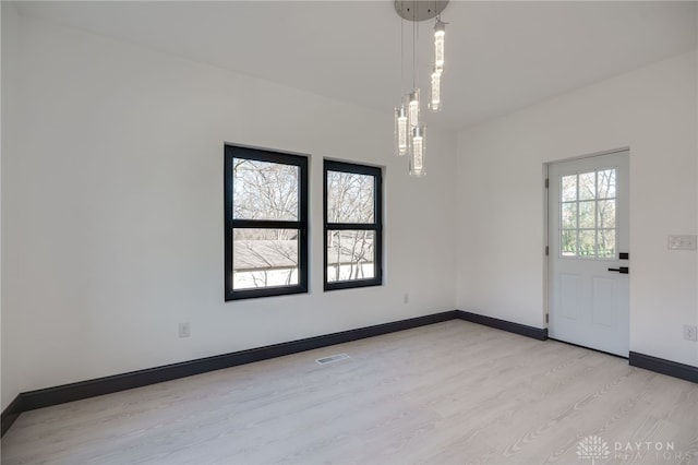 unfurnished room with light hardwood / wood-style floors