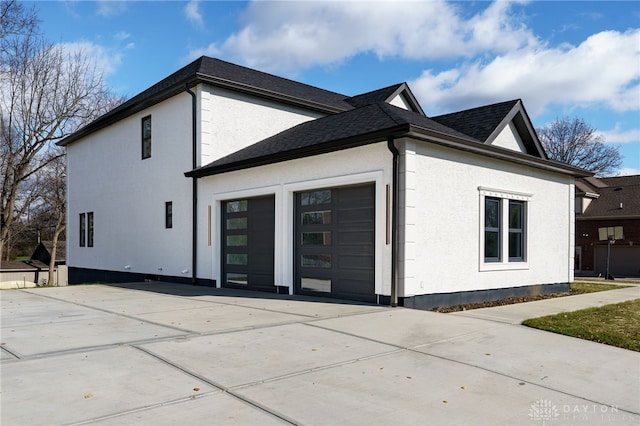 rear view of property featuring a garage