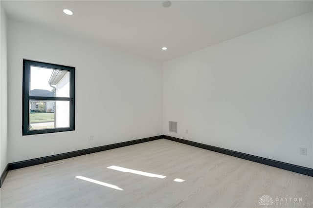 unfurnished room featuring light hardwood / wood-style flooring