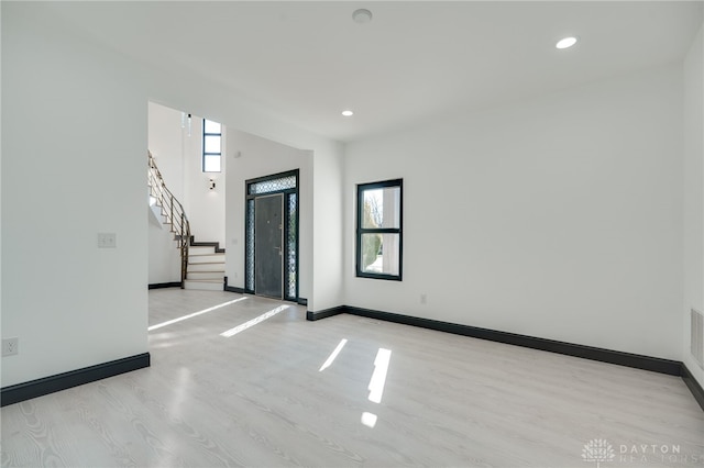 foyer featuring light wood-type flooring and a healthy amount of sunlight