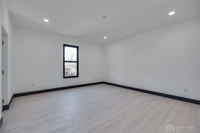 spare room featuring light hardwood / wood-style flooring