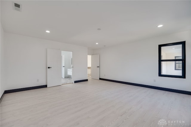 spare room with light hardwood / wood-style flooring