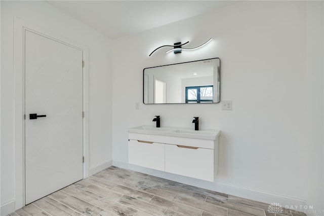 bathroom with vanity and hardwood / wood-style flooring