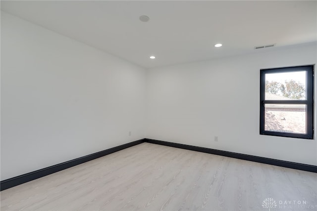 empty room with light hardwood / wood-style flooring