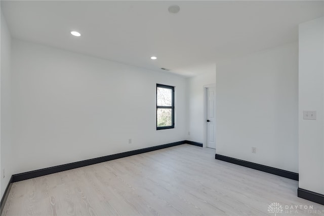 unfurnished room with light hardwood / wood-style flooring