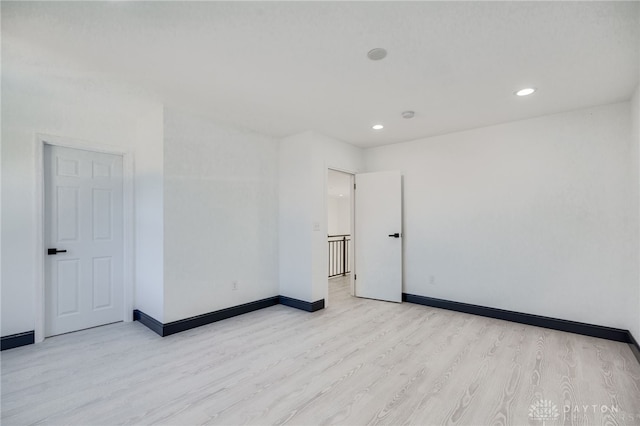 spare room with light hardwood / wood-style floors