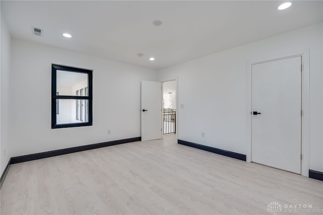 unfurnished room with light wood-type flooring