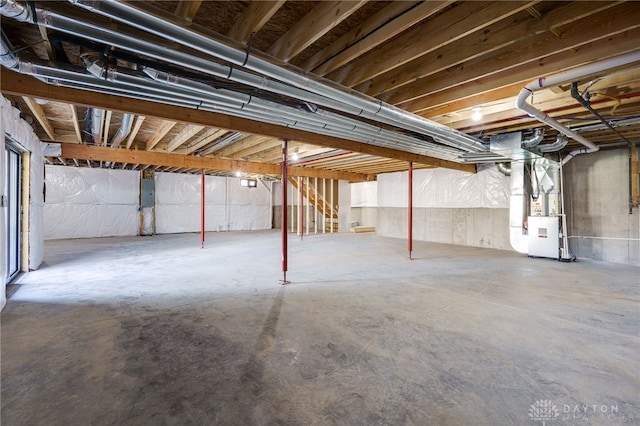 basement with electric panel and heating unit