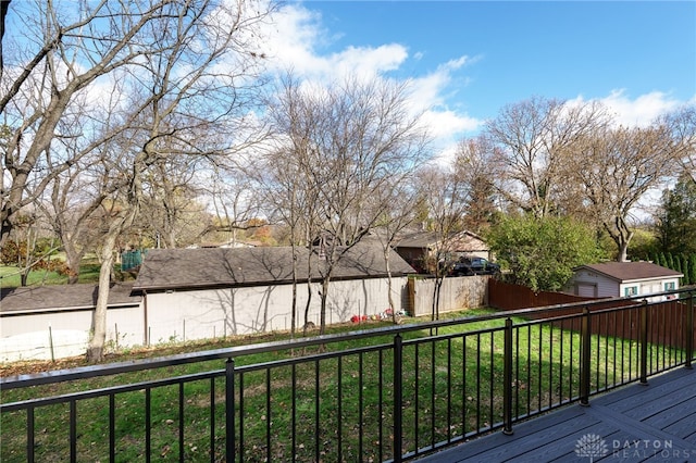 wooden deck featuring a yard