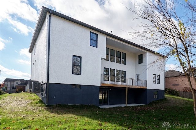 rear view of property featuring a yard