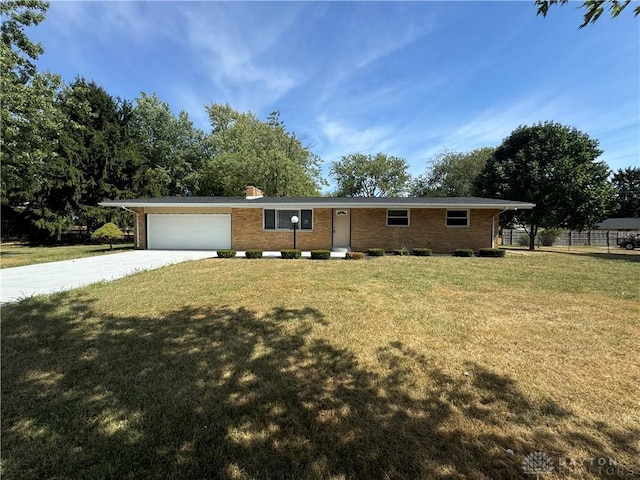 4130 Chalfant Dr, Medway, OH 45341 - ranch-style home with concrete driveway, a chimney, a front yard, brick siding, and a garage