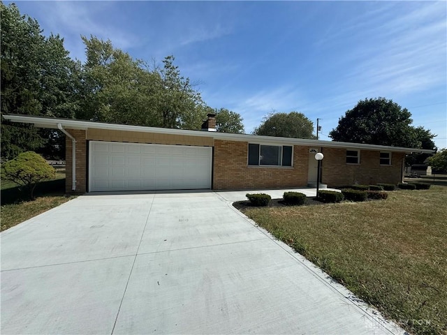 4130 Chalfant Dr, Medway, OH 45341 - ranch-style home featuring a front lawn, brick siding, an attached garage, a chimney, and driveway